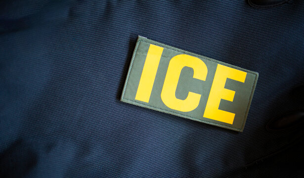 ICE patch on a black background. Negative space on the left.