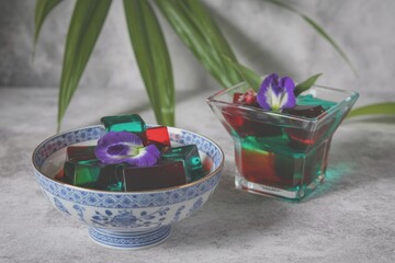 Colorful jellies in bowls with flower decorations