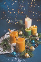 Cozy holiday drinks with candles and decorations