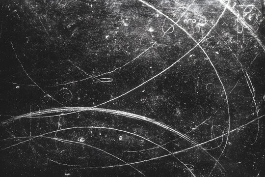 Grunge scratched texture background with abstract white lines on dark surface