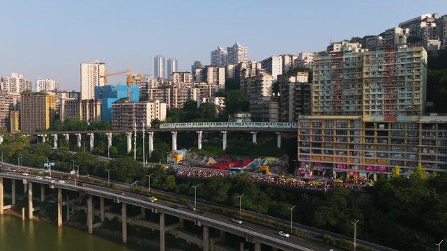 Monorail Train Liziba Passes Directly Through Residential Buildings In Chongqing, China. Aerial Shot