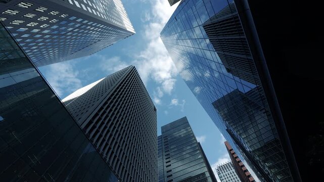 Low angle view of Tokyo skyscrapers in the Shinjuku business district looking up at the sky.