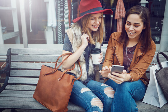 Shopping, women and friends with phone at mall for social media, internet browsing or discount. Smile, online sales and people with tech for mobile deals, promo codes or boutique store purchase