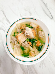 Crispy Pork Wonton Soup on the white bowl.