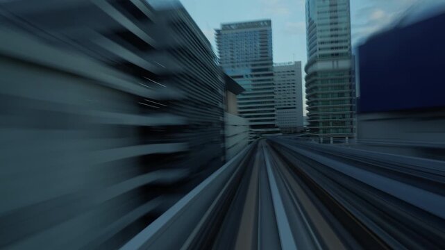Time lapse of automated train moving through Tokyo modern buildings. 
