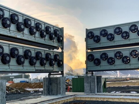 Large direct air capture units with multiple industrial fans extracting carbon dioxide from the atmosphere, symbolizing scalable carbon capture technology for climate mitigation.