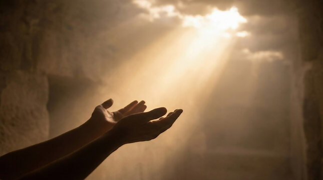 Open hands reaching towards a radiant light beam from above, symbolizing hope, spirituality, faith