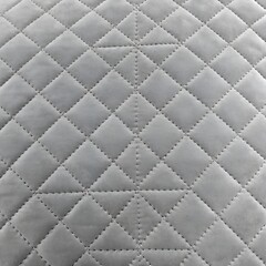 Naklejka premium light grey velvet quilted fabric texture background with geometric diamond stitching