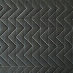 Naklejka premium Dark grey chevron quilted fabric texture background with zigzag stitching
