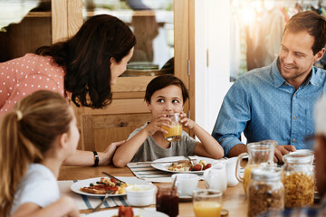 Happy, parents or children in house with breakfast, bonding together or connection in healthy...