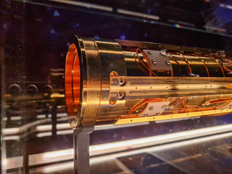 High-tech golden cylindrical component of a quantum computer or particle accelerator.