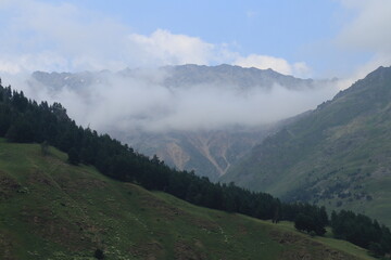 The North Caucasus Mountains in clouds and fog on a summer day