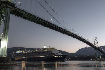 Obraz premium Modern luxury cruiseship cruise ship liner Solstice returning to Vancouver, BC Canada from Alaska cruise during sunrise early morning blue hour harbor landscape marine traffic city skyline silhouette