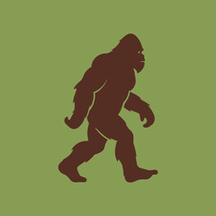 Silhouette of a Bigfoot or Sasquatch walking on a green background.