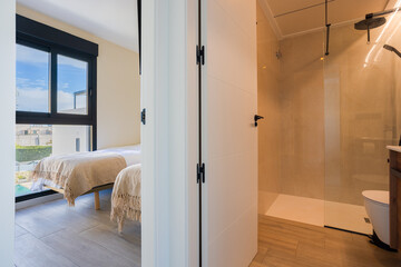 Modern apartment with minimalist bathroom and bright twin bedroom in natural daylight