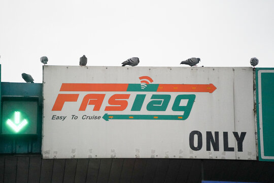Fastag and NHAI national highway authority of India on top of toll booth showing the enforcement fo digital payment only across the country
