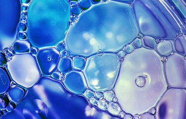 Abstract blue background, colorful oil drops on water surface. Beautiful, natural wallpaper.