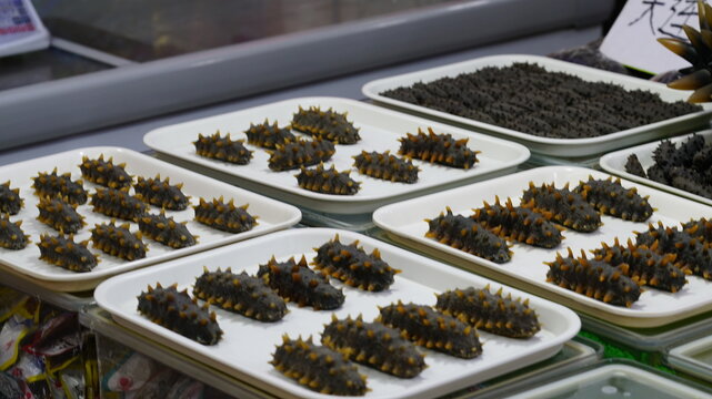 Dried sea cucumbers on display in a store