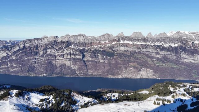 Snowy alpine mountains and Walensee lake viewed from Flumserberg