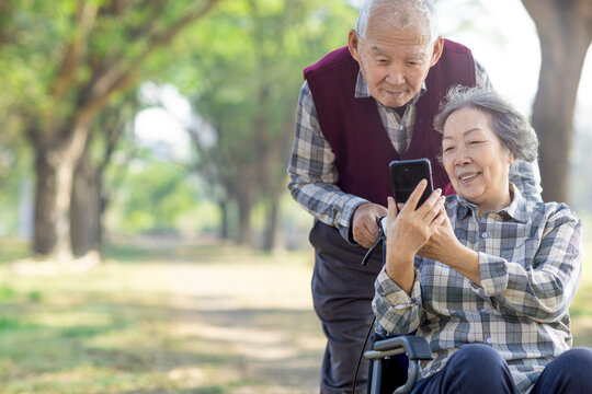 Asian  Elderly Couple Sharing a Digital Memory by the mobile phone