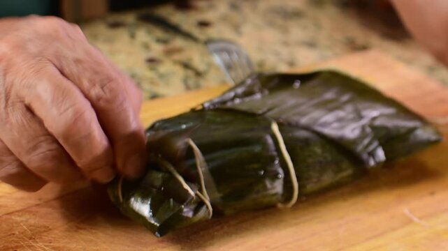 Close Up of Unwrapping Traditional Venezuelan Hallaca in Banana Leaves