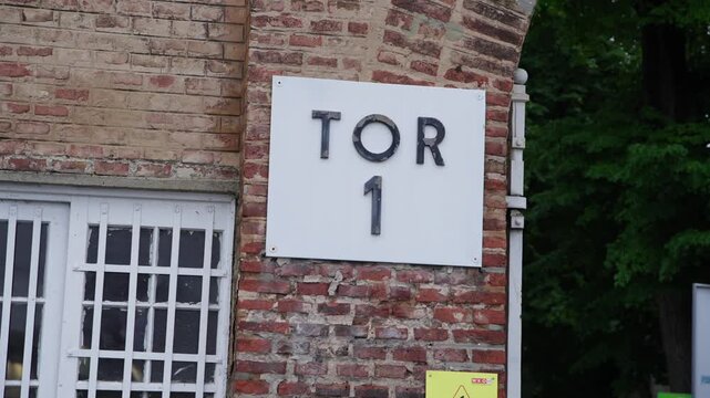 Slow orbit shows TOR Gate 1 entrance sign at Zentralfriedhof cemetery