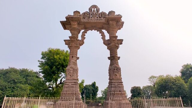 Narsinh Maheta Ni Chowri Vadnagar Gujarat India ancient stone arch monument with detailed carvings, historic cultural landmark, traditional Indian architecture, peaceful outdoor heritage site.