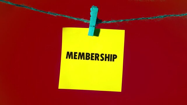 Yellow square notes gracefully display the word membership, appearing letter by letter. Each note is held by a blue clothespin on a delicate string, set against a rich crimson background