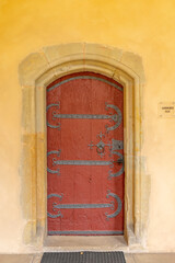 Fototapeta premium Old red door in Treves, Germany, with ornate ironwork