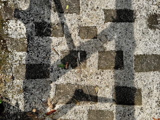 Close up of rough white pebbledash and roughcast gravel with black stone paving as a natural garden footpath for exterior design finishes. Seamless background texture. © TMR Studio