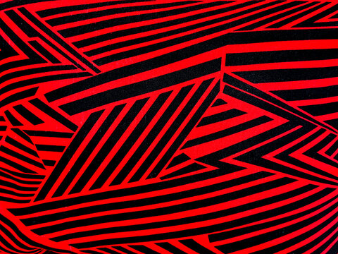 Graphic background of random slanted zig zag red and black lines with futuristic vibes. suitable for fabric, wall covering, and upholstery. seamless background texture. 
