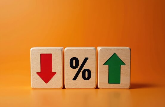Wooden blocks show down arrow red, percentage symbol, up arrow green. Finance concept shows economic change, rates, cost, value. Business growth or loss. Market fluctuation.