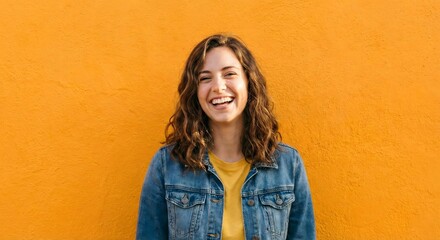 Obraz premium Portrait of happy young woman on yellow background