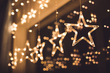 A festive, glowing star-shaped garland. A Christmas celebration on the window.