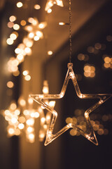 A close-up of a festive, glowing star garland