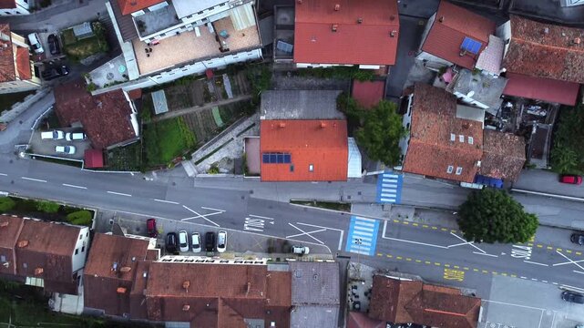 Vertical top down drone shot of orange rooftops and street in Most na Soci.