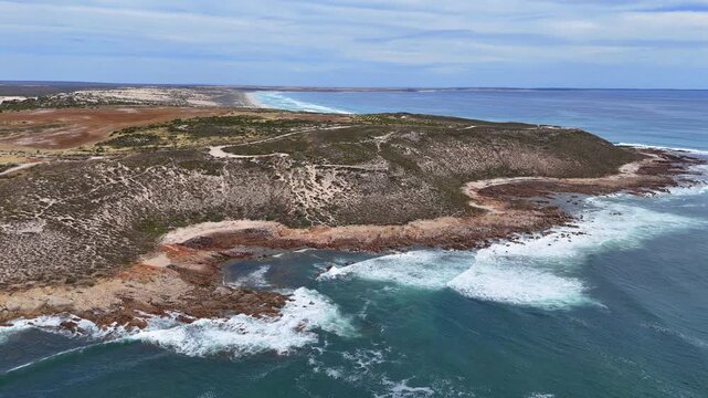 Aerial wide overview of waves crashing against cliffs along Daly Head coastline in South Australia, establish backdrop