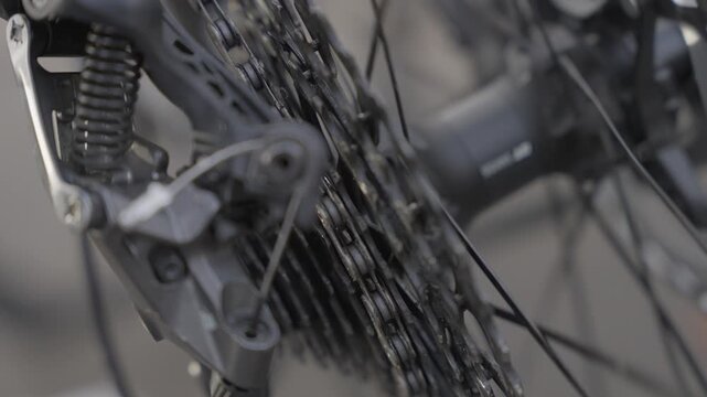 Close up of bicycle drivetrain with rear derailleur and chain motion