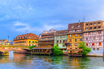 Obraz premium Strasbourg city historic centre, The Petite France Quarter with half-timbered buildings colorful houses and Saint-Martin bridge across River Ill canal in old town Grand Island, Alsace region, France