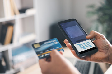 Hands holding smartphone with shopping cart screen and credit card, online checkout and secure mobile payment for ecommerce purchase, fintech banking, digital wallet, cashless transaction.