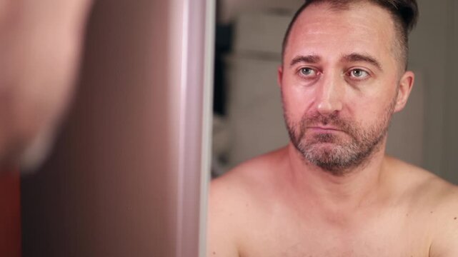 Selfencouraging facial expressions, Private bathroom reflection inspiring confidence boost, Man in bathroom contemplating and encouraging himself with varied facial expressions under warm lighting