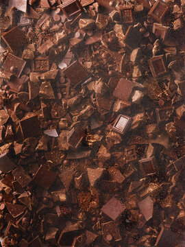 Different chocolate types are seen through wet glass with water droplets, creating a layered view. The combination of light and moisture forms a rich scene of chocolate indulgence