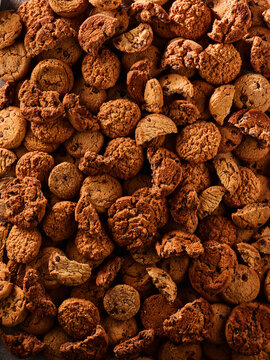 A variety of cookies are placed on a tray. The cookies show different shapes and textures. They are ready for people to enjoy at a gathering or event