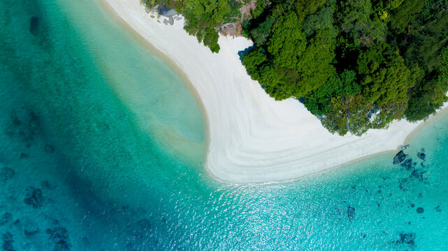 Top view of white sand beach tropical with seashore as the island in a coral reef ,blue and turquoise sea Amazing nature landscape with blue lagoon	