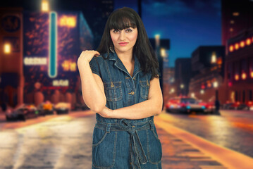 A woman in a purple plaid shirt stands on a city street