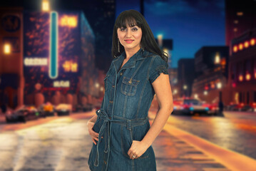 A woman in a purple plaid shirt stands on a city street