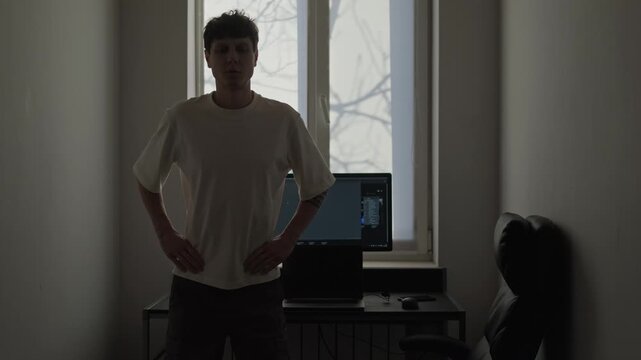 Freelancer stretching in home office during work break, remote work lifestyle, independent worker doing simple exercises near desk for health and productivity