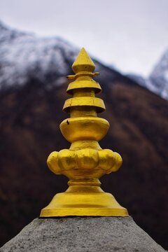 Yellow Buddhist ornaments at Boudhanath Stupa, vertical close-up
