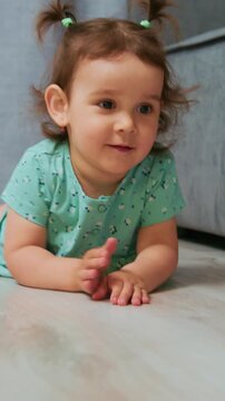 young girl investigates surroundings cheerfully, adorable young girl gropes for colorful toy in warm home