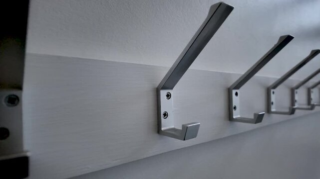 Metal coat hooks in a clean, modern row, providing organization and storage